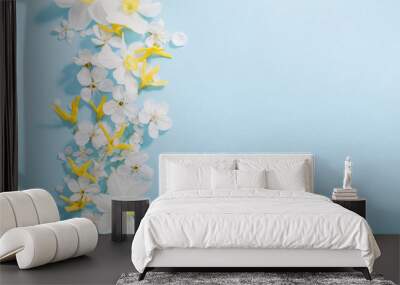 daffodils and cherry flowers on blue background background Wall mural