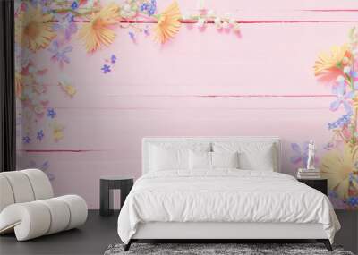 frame of beautiful flowers on pink wooden background Wall mural