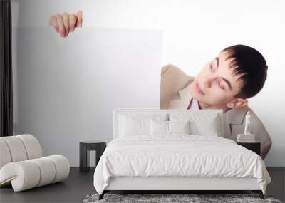 Handsome Businessman holding a blank sign in front of him Wall mural