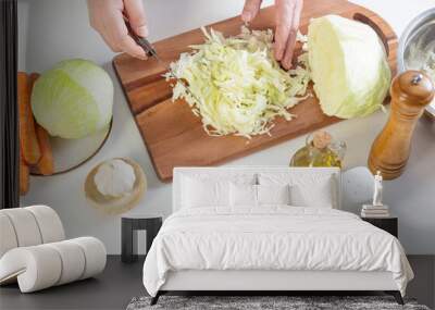 man cutting cabbage in the kitchen at home Wall mural