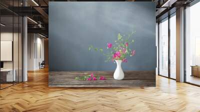 pink summer flowers on wooden table on dark background Wall mural