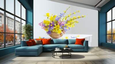 spring flowers in basket on white interior Wall mural