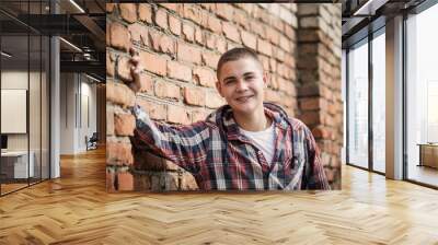 teen boy by brick wall Wall mural