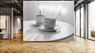 two cups of coffee on white table Wall mural