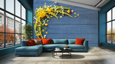 yellow summer flowers on blue wooden background Wall mural