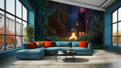 young witch by  fire in night forest Wall mural