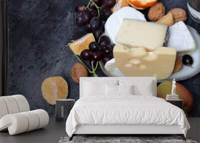 Still life with Dutch cheese and seasonal fruit on dark grey textured background with space for text.  Wall mural