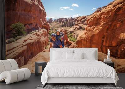 A family with baby son visits Arches National Park in Utah, USA Wall mural