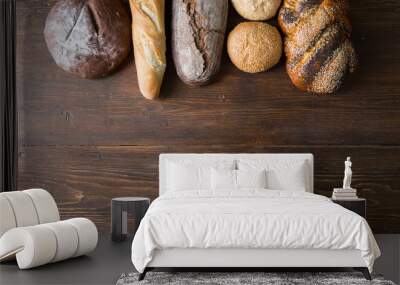 Fresh baked bread at wooden table Wall mural