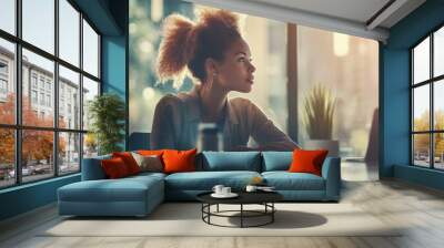 Woman with curly hair looking out the window Wall mural