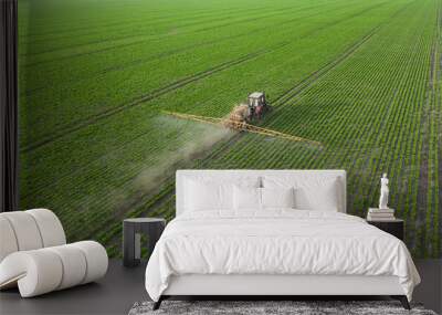 The tractor sprays crops with herbicides, insecticides and pesticides. Wall mural