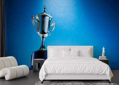 low angle view of winning trophy against blue background Wall mural