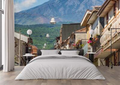 Typical sicilian street with a view at Etna volcano eruption in Piedimonte Etneo town, Sicily Wall mural