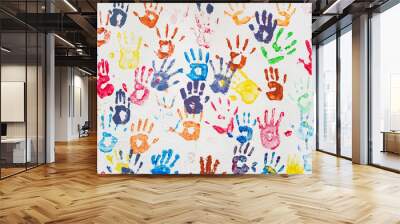 White wall with colorful multicolored hand prints. Wall mural