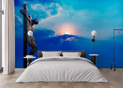 Jesus Christ on the cross over blue dramatic sky background Wall mural