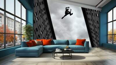 Man jumping from roof to roof Wall mural