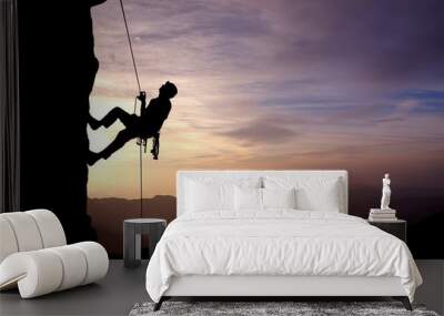 Silhouette of Rock Climber at Sunset Wall mural