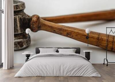 A close-up of a weathered metal hammer with a wooden handle isolated on a white background. Wall mural