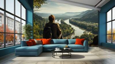 a person with a back view sitting on the edge of a cliff. Stunning views across a rugged cliff landscape Wall mural