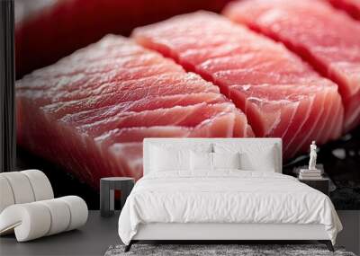 Fresh raw fish fillets on a black surface with sea salt. Wall mural