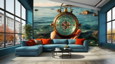 View of woman's hand with compass on beautiful sea landscape background Wall mural