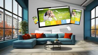 computer, tablet and smartphone gravity showing pet care responsive website Wall mural