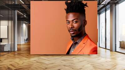 A handsome Black man Confident smile portrait of a young Black man in a vibrant orange suit against a bold orange backdrop Wall mural