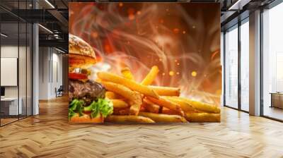 A juicy cheeseburger with fries and cola on the side, set against an flame abstract background. with melted cheese between buns. Wall mural