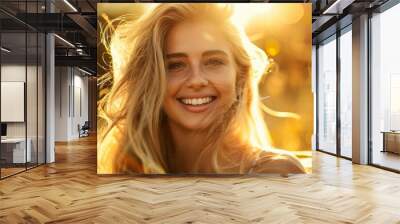 Beautiful woman with long blonde hair smiles at the camera. Summer outdoor scene, glowing skin and a radiant smile, bathed in the warm light of the setting sun. Her long blonde hair flows in breeze Wall mural