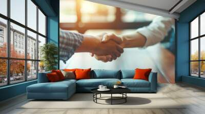 Business woman shaking hands with a male colleague Two businesspeople in suits shaking hands after a successful meeting Wall mural