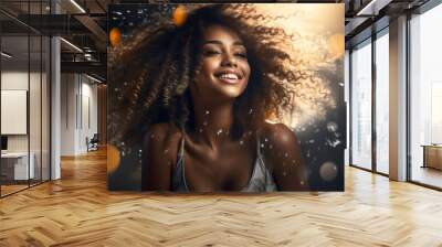 Cute afro haired young woman looking happy on the black background Wall mural