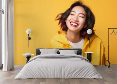 Happy ultra beauty girl, who is smiling and laughing, wearing bright outdoor clothes. Bright solid background. Wall mural