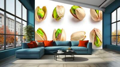 Pistachio nuts in various positions isolated on a white background Wall mural