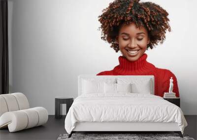 Portrait of smiling happy african american woman using smartphone isolated on white background, wearing red sweater with copy space for text or promotion banner. Wall mural