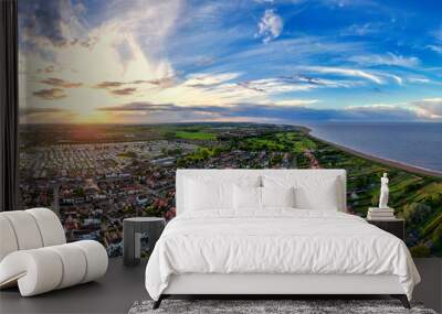 Sunset Aerial Panoramic View of the UK Seaside Skegness, a busy tourist town with something for everyone, from stunning campsites to a sunset to die for, showcases the beauty of a serene sunset Wall mural