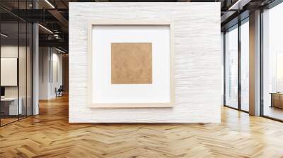 Square empty photo frame on wooden wall Wall mural