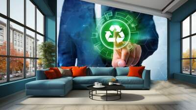 Businessman pointing at green recycle symbol or sign with his finger on digital display screen. Ecology and environment conservation and sustainability concept. Corporate company management  Wall mural