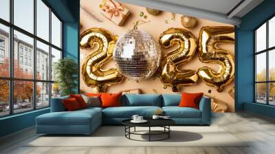 Happy New Year 2025 and Merry Christmas! Two glasses of champagne, a golden champagne bucket and Christmas balls and tinsel on a light background Wall mural