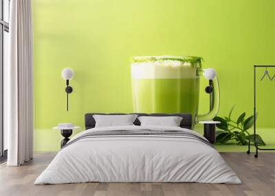 Matcha green tea latte in a glass on green yellow background. Healthy vegan drink with plant Wall mural