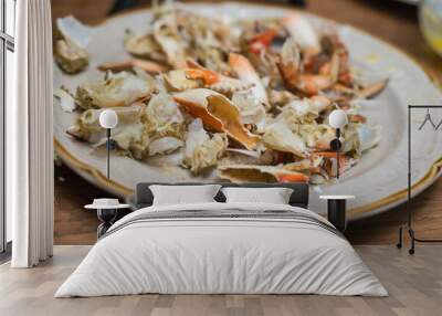 Shells of crab left on plate after finishing meal Wall mural