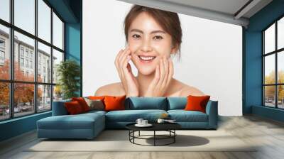 Beautiful Asian woman happy touching her skin facial face care on white background. Beauty female with natural makeup and perfect skin. Wall mural