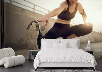 Focus sport shoe, Runner doing stretching exercises on stair before running at sunset. Asian woman warm up stretching exercise in park outdoor. Wall mural