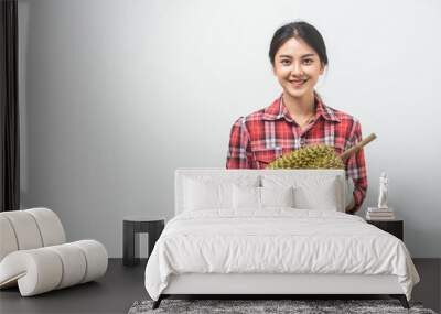 Portrait Asian young woman she smiling and holding durian fruit. Female farmer happy holding durian fruit in studio white background. Wall mural