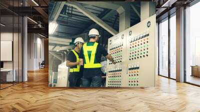 Two Electrical Engineer team working front control panel, Engineer training job with control panel in service room. Wall mural