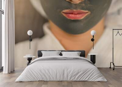 woman with facial mask on her face Wall mural