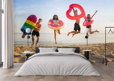  Holiday summer party with friends on the beach .Group of family and friends  jumping on the beach. lifestyle people vacation holiday on beach Wall mural