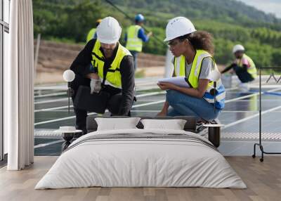 Engineers, males  inspecting solar panels on the roof, inspecting safety and cleaning services. Construction industry, construction personnel
 Wall mural