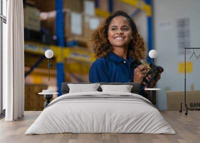 industrial worker in factory, worker woman smiling working in warehouse stock checking. happy work black girl in factory Wall mural