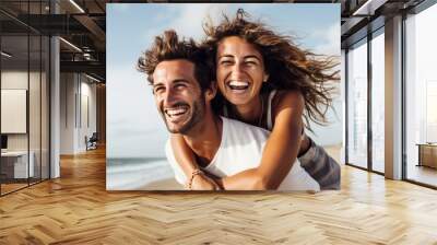 Couple enjoys a piggyback ride at the beach in summer, portrait shot, joyful Wall mural