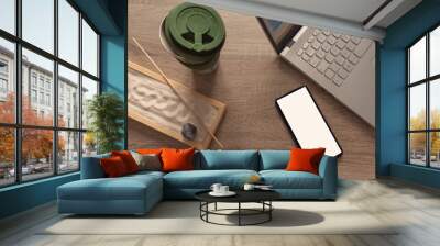 Flat lay, top view of a office table desk. Workshop layout with smartphone, laptop, coffee mug, and zen garden on wooden background. Copy space. Wall mural